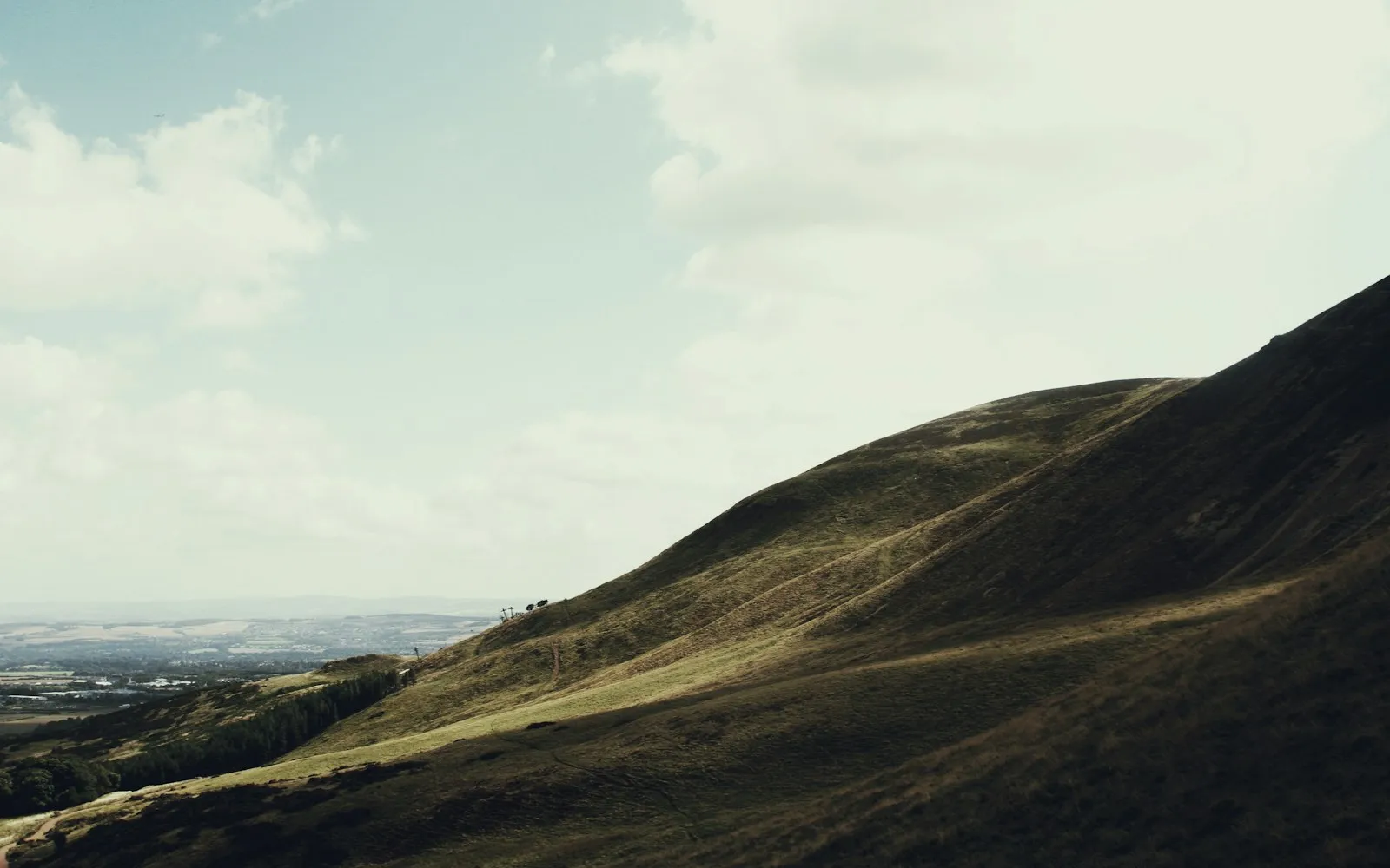 A green valley rolling toward distant mountains