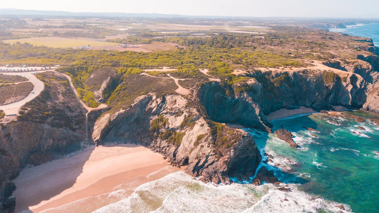 An aerial view of a wide beach and coastline