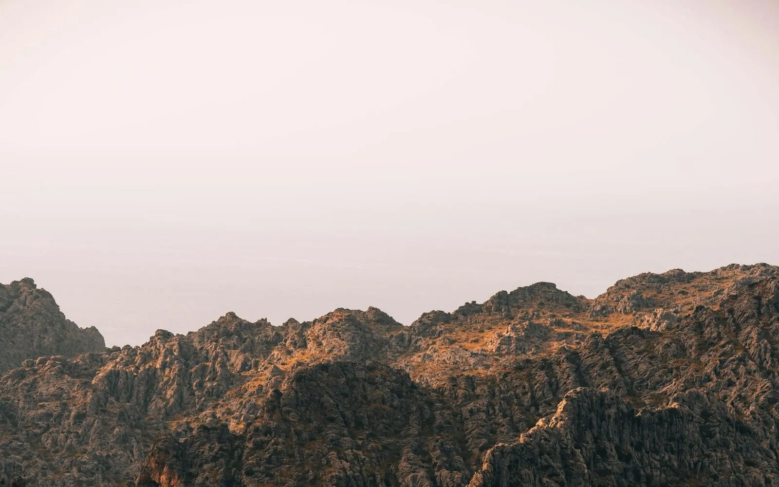 Dawn light illuminating rugged mountain peaks