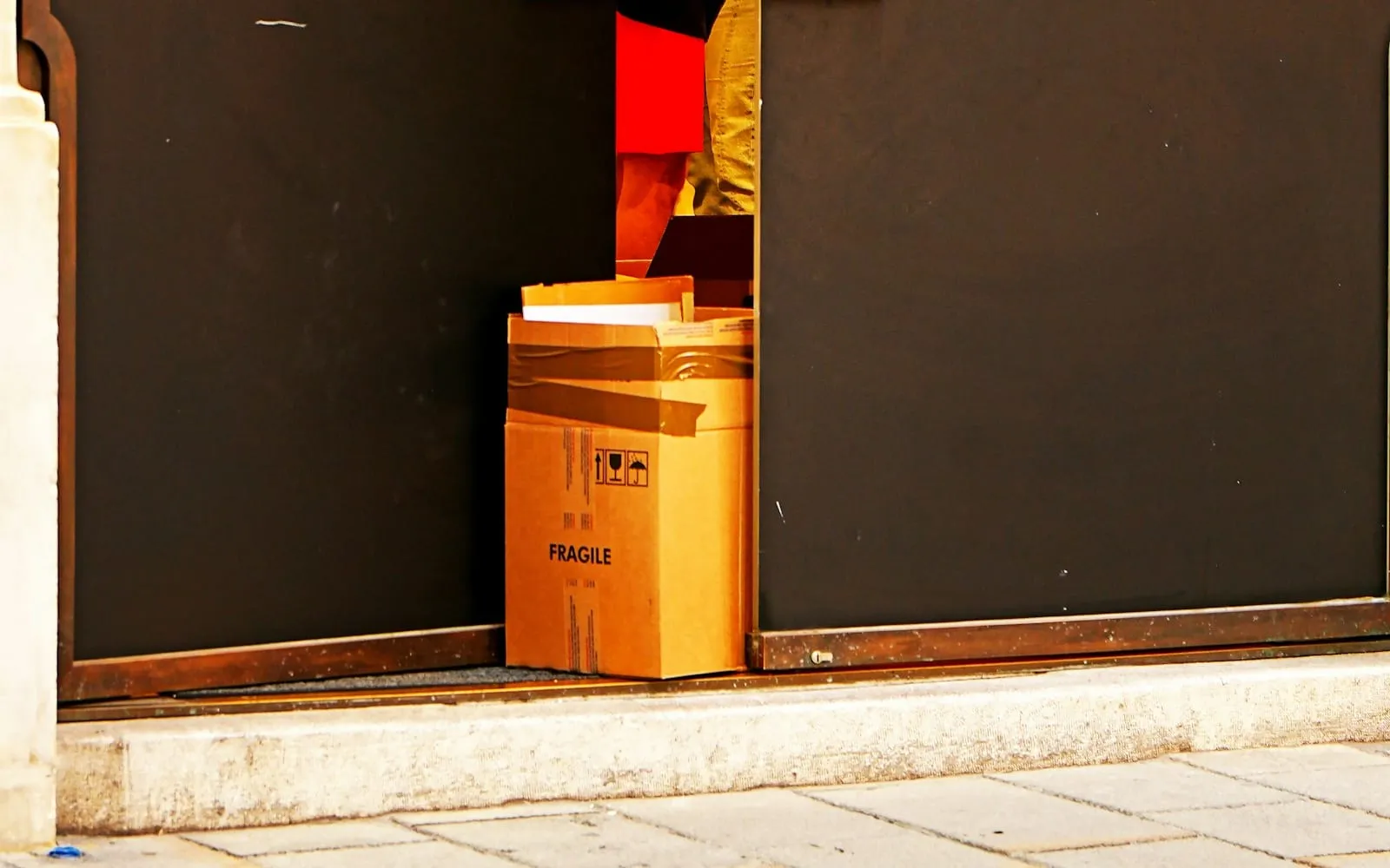 A cardboard parcel waiting by a doorway